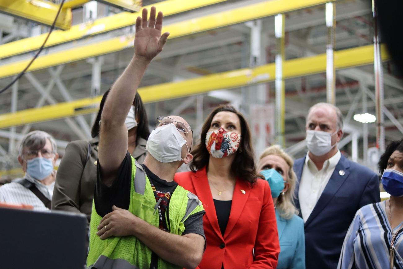 Gov. Gretchen Whitmer tours Ford Motor Co.’s Rouge Electric Vehicle Center in Dearborn in 2021. People are wearing masks.