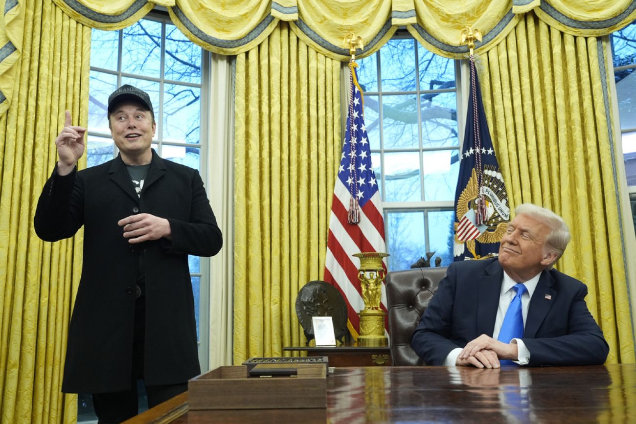 Elon Musk standing to Donald Trump. 