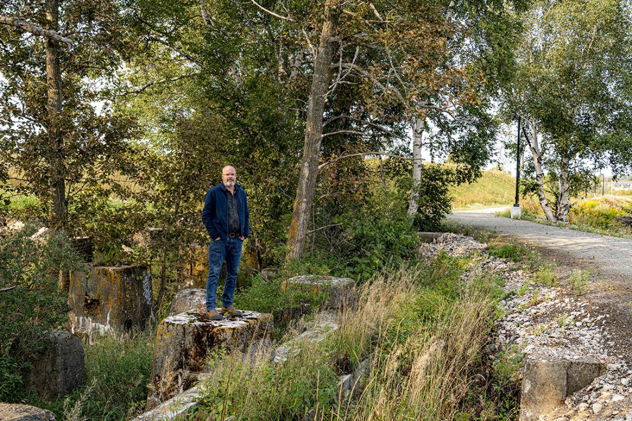 Guy Walter stands on a tree stump. 
