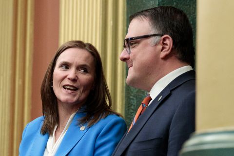  Senate Majority Leader Winnie Brinks, D-Grand Rapids, and House Speaker Matt Hall, R-Richland Township, speaking to each other.