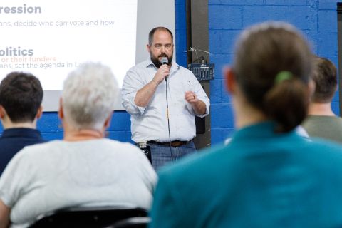 Man speaks to crowd