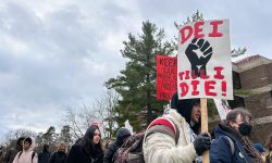 Some holding a sign that says "DEI until I die."